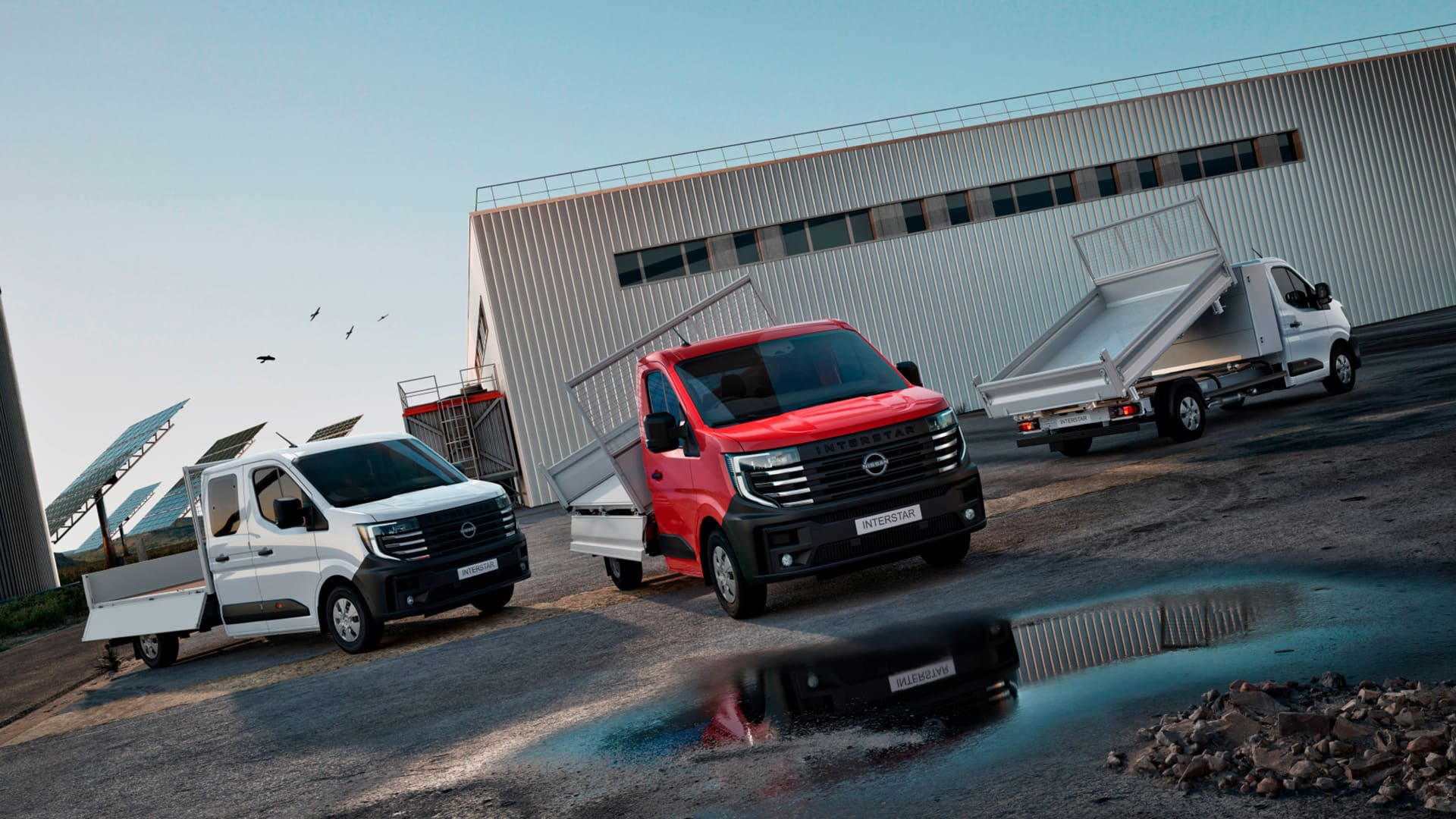 Nissan Interstar Van bodies and conversions parked in front of solar panels